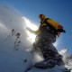 Jeremy Jensen surfing thru the snow and weeds without any bindings on his Grassroots Powsurfer